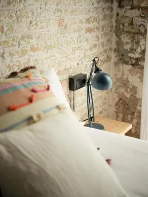 a bedroom with a bed and a desk with a lamp at Poble Nou I You Stylish Apartments in Barcelona
