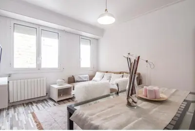 a white living room with a bed and a table at Nordic Apartment II Sagrada Familia in Barcelona
