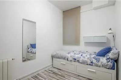 a bedroom with a bed and a mirror at Nordic Apartment II Sagrada Familia in Barcelona