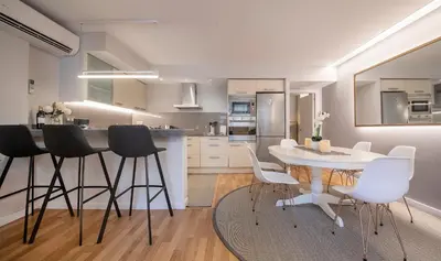 a kitchen with a table and chairs in a kitchen at Poble Nou II You Stylish Apartments in Barcelona