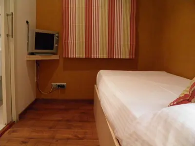 a bedroom with a bed and a tv on a shelf at Hotel Annex - Rey Don Jaime I in Barcelona