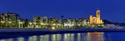 a city lit up at night with a building at Sol & Relax en centro, Sitges. in Sitges