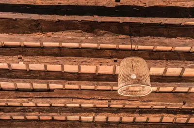 a hat hanging from the side of a wooden stairs at Masia Mediterranian Country House Ca l'Isidre Torrent in Sant Cebrià de Vallalta