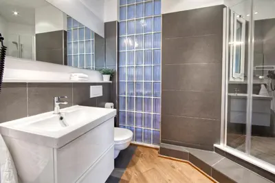 a bathroom with a sink and a toilet and a shower at Habitat Apartments Rambla Deluxe in Barcelona
