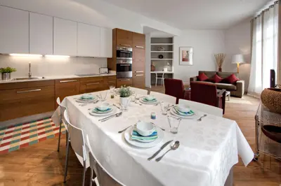 a kitchen with a table with a white table cloth at Habitat Apartments Rambla Deluxe in Barcelona