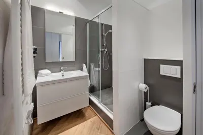 a bathroom with a toilet and a sink and a shower at Habitat Apartments Rambla Deluxe in Barcelona