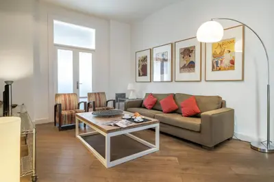 a living room with a couch and a table at Habitat Apartments Rambla Deluxe in Barcelona