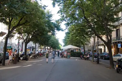 a street with a group of people walking down the street at Habitat Apartments Rambla Deluxe in Barcelona
