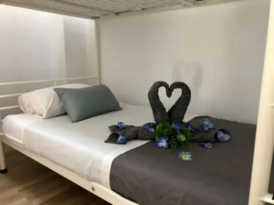 a bed with a stuffed animal and flowers on it at Vilamarlux III in Vilassar de Mar