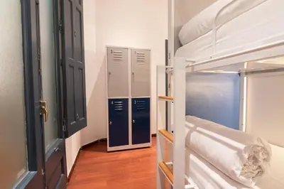 a room with two bunk beds and a hallway at The Central House Barcelona Gracia in Barcelona