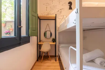 a small room with a bunk bed and a desk at The Central House Barcelona Gracia in Barcelona
