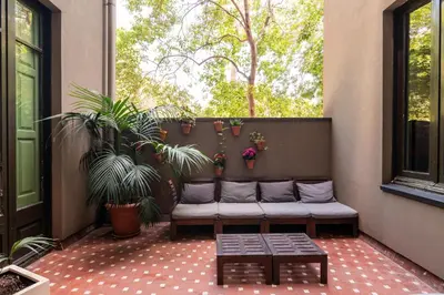 a porch with a couch and plants and a window at The Central House Barcelona Gracia in Barcelona