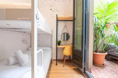 a room with a bunk bed and a desk at The Central House Barcelona Gracia in Barcelona