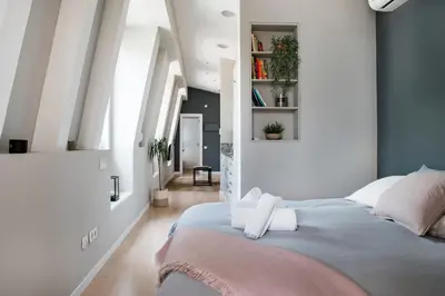 a bedroom with a bed with towels on it at El Alma de las Ramblas in Barcelona