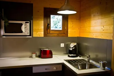 a kitchen with a sink and a microwave at Refugio cálido,estilo nórdico el Bosquet in Sant Cugat del Vallès