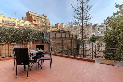 a patio with a table and chairs on a balcony at AB Passeig de Gràcia Còrsega in Barcelona