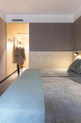 a person walking in a bedroom with a large bed at Hotel Raval House in Barcelona