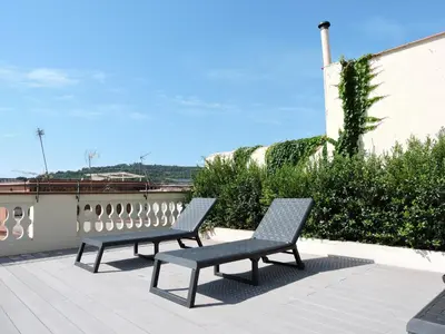 two benches sitting on top of a roof at Hotel Raval House in Barcelona
