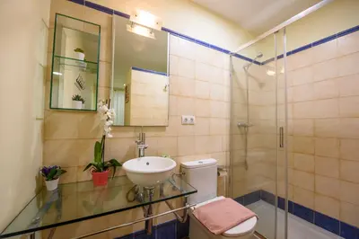 a bathroom with a sink and a toilet and a shower at RamblasRentals Chic & Spacious Flat Pool Table 15M Ramblas - Parking - Wifi in Barcelona