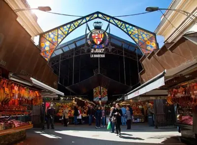 a group of people walking through a market at RamblasRentals Chic & Spacious Flat Pool Table 15M Ramblas - Parking - Wifi in Barcelona