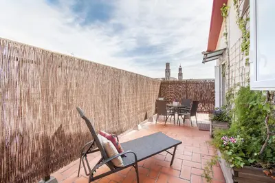 a patio with chairs and a table and a fence at BCNGOTIC 50 in Barcelona