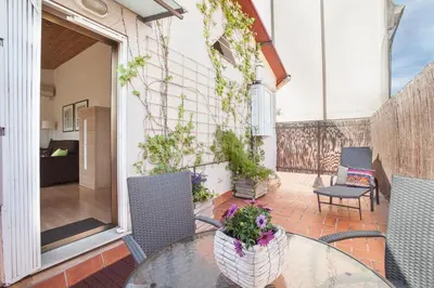 a patio with a table and chairs on a balcony at BCNGOTIC 50 in Barcelona