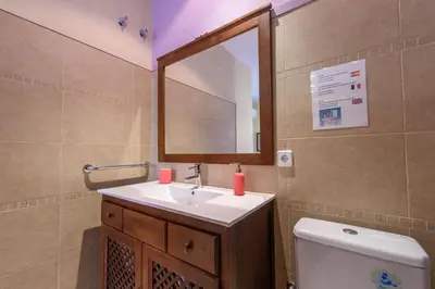 a bathroom with a sink and a mirror and a toilet at RamblasRentals Design Renovated Apartment AC Balcony10m Ramblas - Parking - Wifi in Barcelona