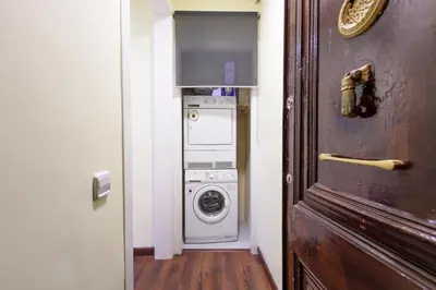 a hallway with a washer and dryer in a room at RamblasRentals Design Renovated Apartment AC Balcony10m Ramblas - Parking - Wifi in Barcelona
