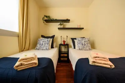 two beds with towels on them in a room at RamblasRentals Stylish Bright 3BR New Catalan Flat 10m Ramblas - Parking - Wifi in Barcelona