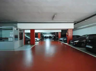 a parking garage with cars parked in it at RamblasRentals Stylish Bright 3BR New Catalan Flat 10m Ramblas - Parking - Wifi in Barcelona