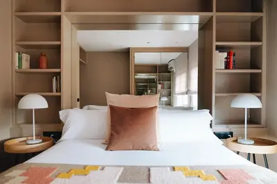 a bedroom with a large white bed with two lamps at Isabella's House in Barcelona