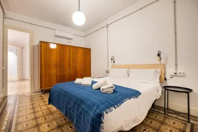 a bedroom with a large bed with towels on it at b42 - MODERNIST APARTMENT FOR LARGE GROUPS IN EIXAMPLE in Barcelona