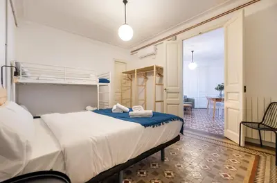 a bedroom with a large bed with towels on it at b42 - MODERNIST APARTMENT FOR LARGE GROUPS IN EIXAMPLE in Barcelona