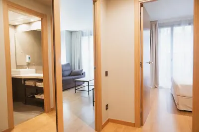 a view of a room with a bed and a bathroom at Apartments Hotel Sant Pau in Barcelona