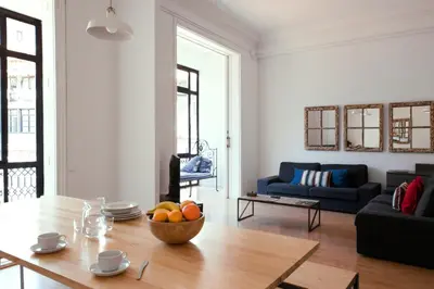 a living room with a table with a bowl of fruit on it at My Address in Barcelona in Barcelona