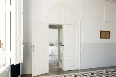 a white door in a room with a tile floor at My Address in Barcelona in Barcelona