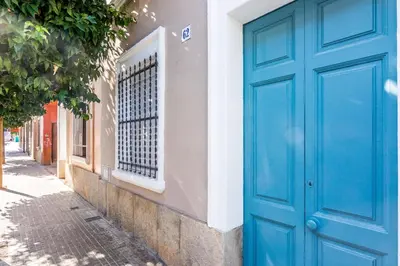a blue door on the side of a building at HomeHolidaysRentals Arlene in Calella