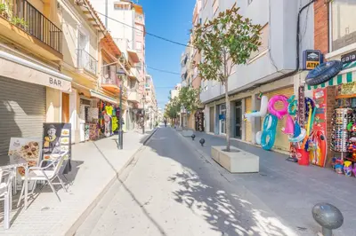 an empty street in a city with buildings at HomeHolidaysRentals Arlene in Calella