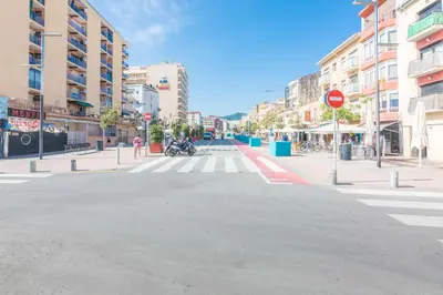 an empty street with a crosswalk in a city at HomeHolidaysRentals Arlene in Calella