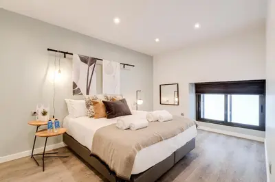 a bedroom with a large bed and a window at Sweett - Verdi in Barcelona