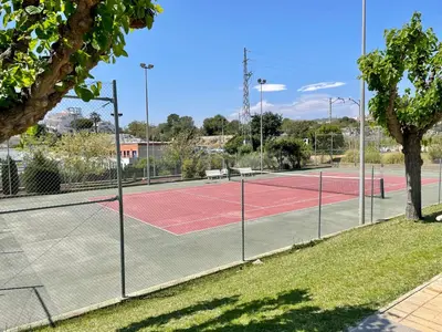 a tennis court with two tennis courts at La Marina SeaView Penthouse in Sitges