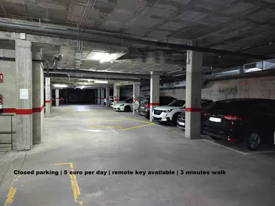a parking garage with cars parked in it at Luxury Apartment Accommodation, next to beach & train station Calella in Calella