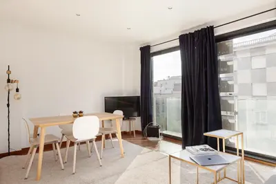 a dining room with a table and a window at Enjoy Apartments Maria in Barcelona