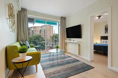 a living room with a couch and a tv at Tendency Apartments Forum 4 in Sant Adria de Besos