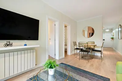 a living room with a flat screen tv and a table at Tendency Apartments Forum 4 in Sant Adria de Besos