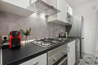 a kitchen with a stove and a sink at Tendency Apartments Forum 4 in Sant Adria de Besos