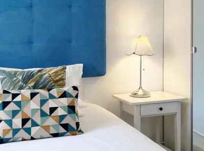 a bedroom with a bed with a lamp on a side table at Stay U-nique Apartments Legalitat in Barcelona