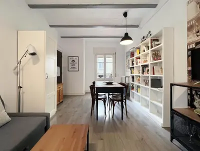 a living room and dining room with a table and chairs at Stay U-nique Apartments Legalitat in Barcelona