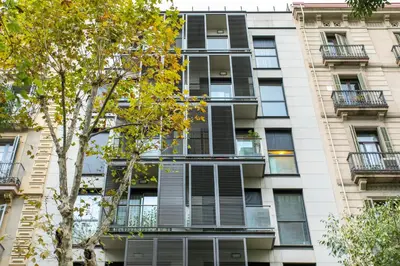 an apartment building with windows and a tree at Stay U-nique Apartments Plaça de Tetuan in Barcelona