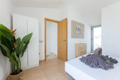 a bedroom with a bed and a potted plant at matarolux17 in Mataró